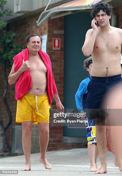 Comedian Barry Humphries and his son Rupert Humphries walk after a swim at Bronte Beach on January 1, 2010 in Sydney, Australia.