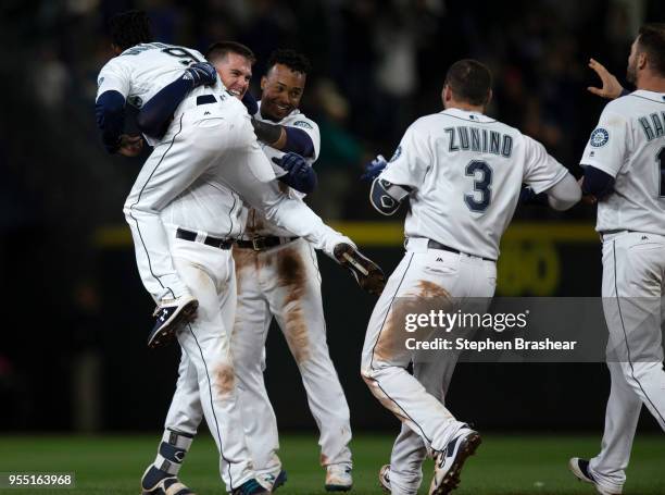 From left, Dee Gordon of the Seattle Mariners, and teammates Ryon Healy, Jean Segura, Mike Zunino and Mitch Haniger celebrate after Healy hit...