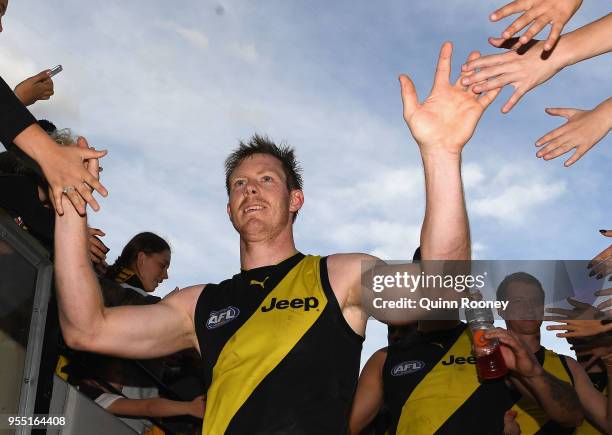 Jack Riewoldt of the Tigers high fives fans after winning the round seven AFL match between the Richmond Tigers and the Fremantle Dockers at...