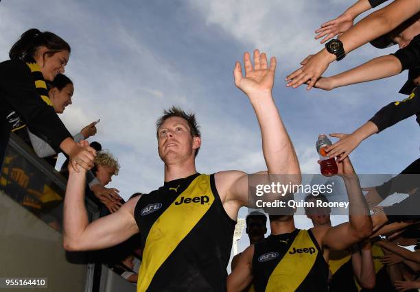 Jack Riewoldt of the Tigers high fives fans after winning the round seven AFL match between the Richmond Tigers and the Fremantle Dockers at...