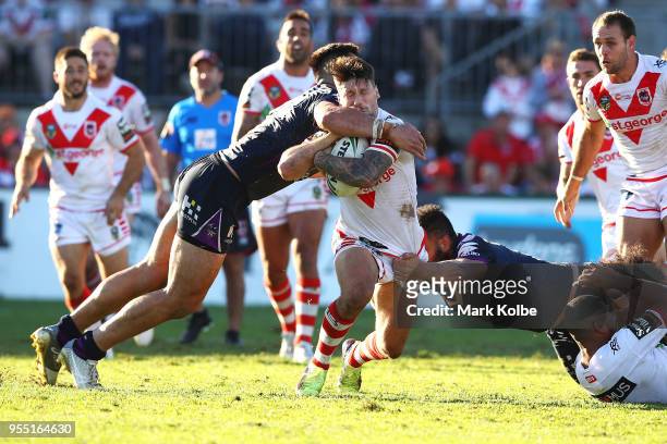 Nelson Asofa-Solomona of the Storm hits Gareth Widdop of the Dragons high in a tackle during the round nine NRL match between the St George Illawarra...