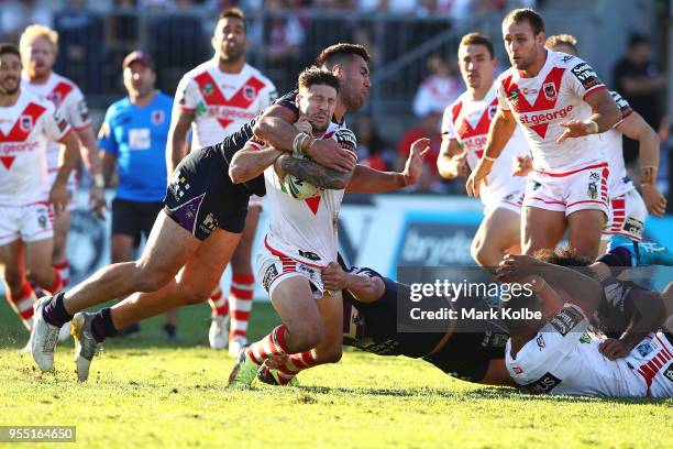 Nelson Asofa-Solomona of the Storm hits Gareth Widdop of the Dragons high in a tackle during the round nine NRL match between the St George Illawarra...