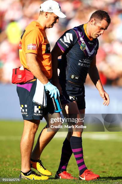 Cameron Smith of the Storm receives attention from the trainer during the round nine NRL match between the St George Illawarra Dragons and the...