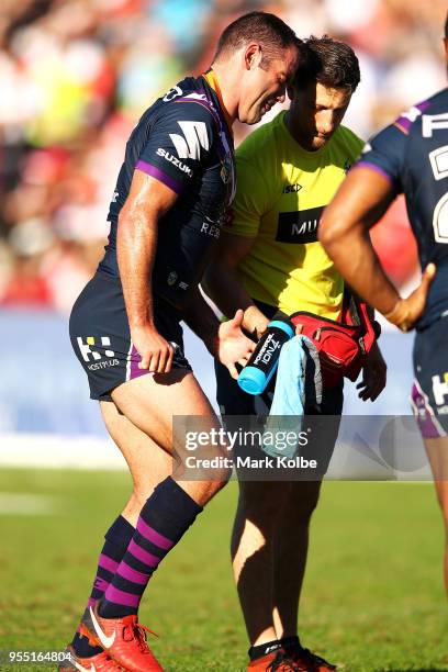 Cameron Smith of the Storm receives attention from the trainer during the round nine NRL match between the St George Illawarra Dragons and the...