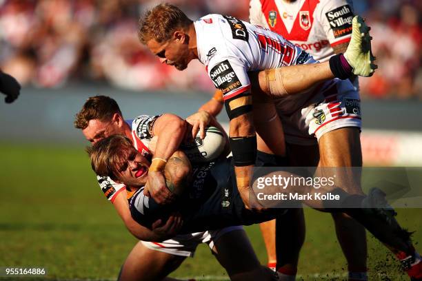 Cameron Munster of the Storm is tackled Matt Duffy and Jack De Belin of the Dragons during the round nine NRL match between the St George Illawarra...