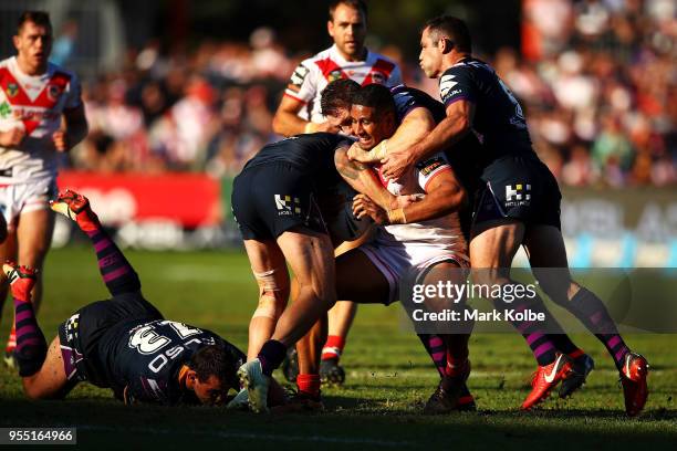 Nene Macdonald of the Dragons is tackled during the round nine NRL match between the St George Illawarra Dragons and the Melbourne Storm at UOW...