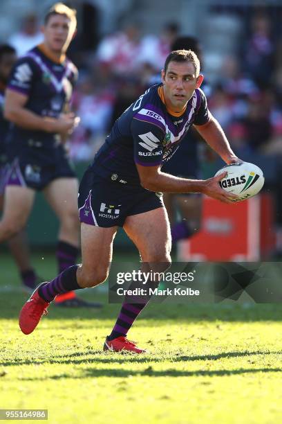 Cameron Smith of the Storm looks to pass during the round nine NRL match between the St George Illawarra Dragons and the Melbourne Storm at UOW...