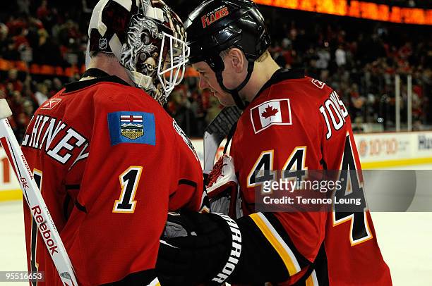Curtis McElhinney and Aaron Johnson of the Calgary Flames celebrate a 2-1 win over the Edmonton Oilers on December 31, 2009 at Pengrowth Saddledome...