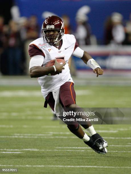 Quarterback Tyrod Taylor of the Virginia Tech Hokies runs with the ball during the Chick-Fil-A Bowl against the Tennessee Volunteers at the Georgia...