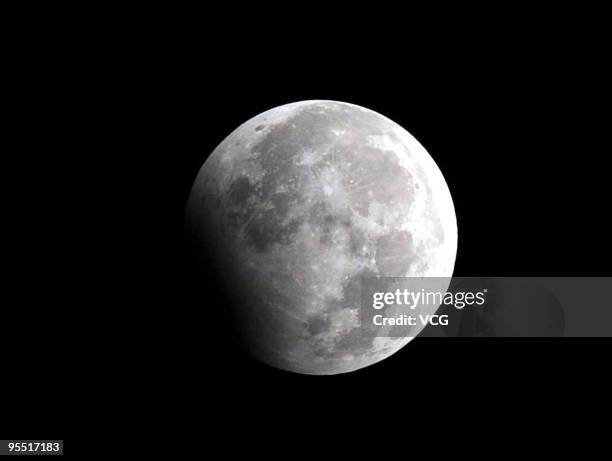 Partial lunar eclipse is seen on January 1, 2010 from Jiaxing, Zhejiang Province of China. The eclipse, which coincided with the first day of the new...