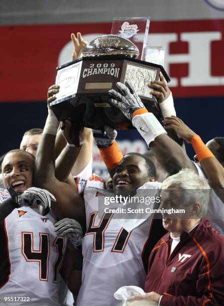 Nekos Brown, Head Coach Frank Beamer and Cam Martin of the Virginia Tech Hokies celebrate after the Chick-Fil-A Bowl game against the Tennessee...