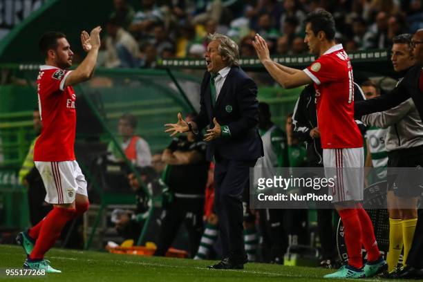 Sporting's coach Jorge Jesus reacts, nexts to Benfica's Serbian midfielder Andrija Zivkovic and Benfica's Brazilian forward Jonas during the...
