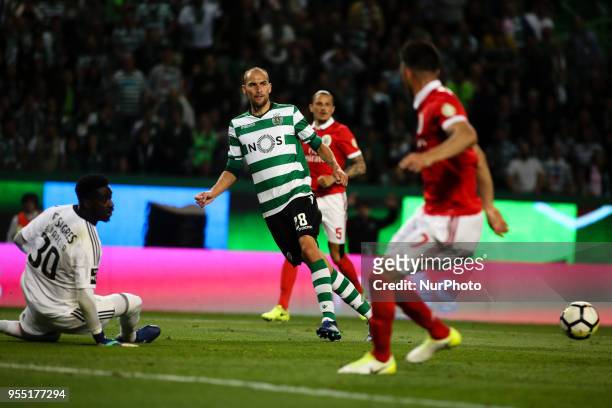 Sporting's Dutch forward Bas Dost vies with Benfica's goalkeeper Bruno Varela during the Portuguese League football match between Sporting CP and SL...