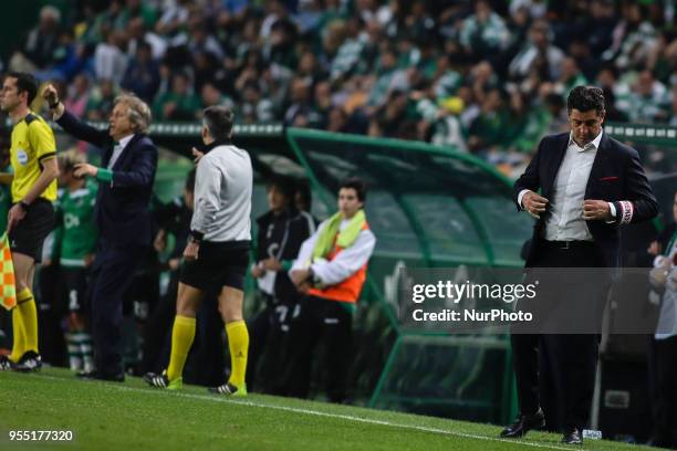 Benfica's coach Rui Vitoria reacts next to Sporting's coach Jorge Jesus during the Portuguese League football match between Sporting CP and SL...