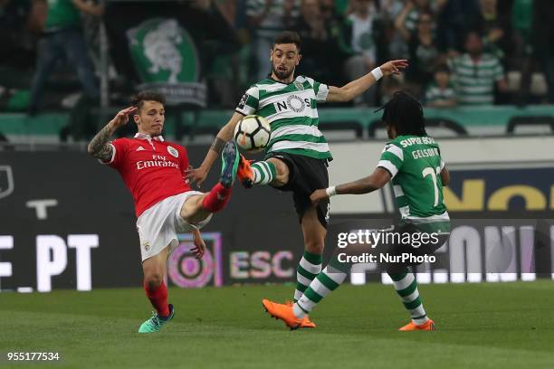 Benfica's Spanish defender Alejandro Grimaldo fights for the ball with Sporting's midfielder Bruno Fernandes from Portugal during the Primeira Liga...