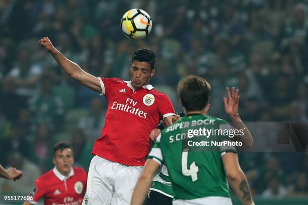 Benfica's Mexican forward Raul Jimenez heads the ball during the Primeira Liga football match Sporting CP vs SL Benfica at the Alvadade stadium in...