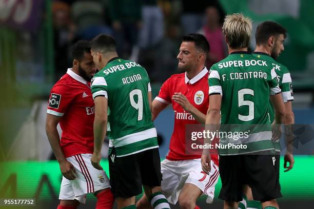 Sporting's midfielder Marcos Acuna from Argentina argues with Benfica's Brazilian defender Douglas during the Primeira Liga football match Sporting...