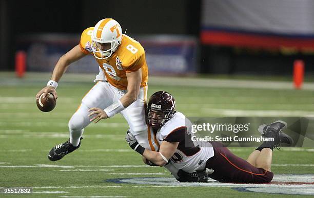 Cody Grimm of the Virginia Tech Hokies sacks Jonathan Crompton of the Tennessee Volunteers during the Chick-Fil-A Bowl game at the Georgia Dome on...