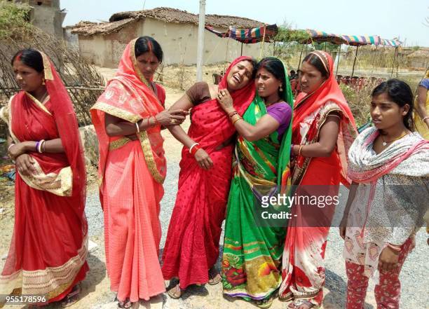 In this photograph taken on May 5 Indian relatives mourn following the rape and murder of a 16-year-old girl on May 3, at Raja Kundra Village in...