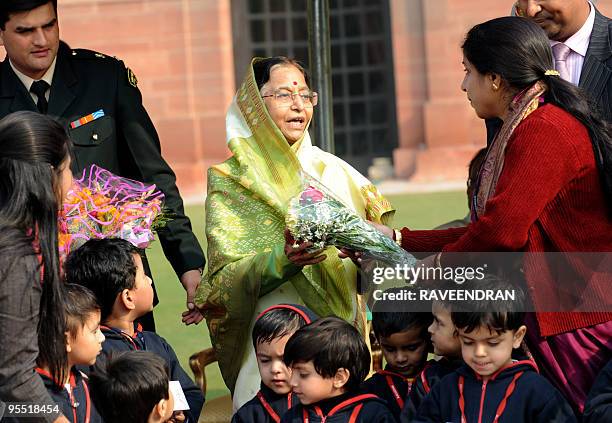 Indian President Prathibha Patil is greeted by schoolchildren and their teacher during a reception at Rashtrapati Bhawan - The Presidential Palace in...