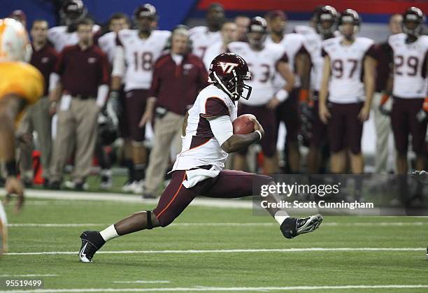 Tyrod Taylor of the Virginia Tech Hokies scrambles during the Chick-Fil-A Bowl game against the Tennessee Volunteers at the Georgia Dome on December...