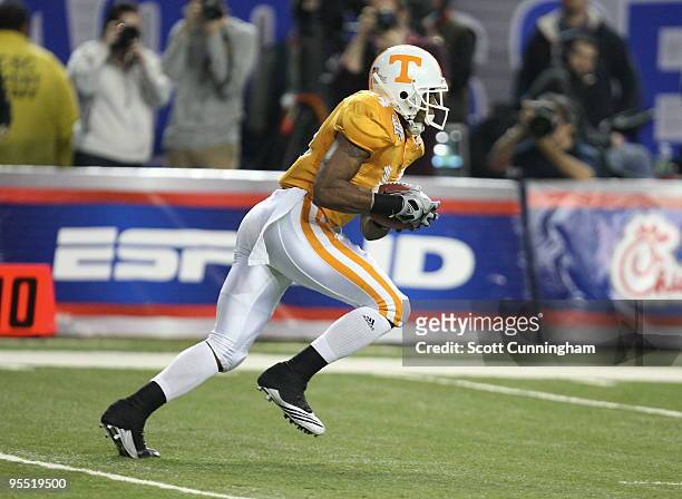 Eric Berry of the Tennessee Volunteers returns a kick during the Chick-Fil-A Bowl game against the Virginia Tech Hokies at the Georgia Dome on...