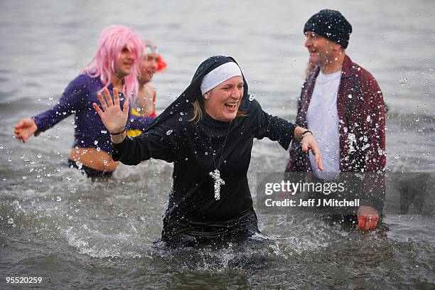 New Year revellers, many in fancy dress, braved freezing conditions at the River Forth in front of the Forth Rail Bridge during the Loony Dook Swim...