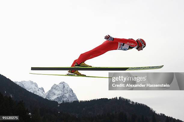 Michael Uhrmann of Germany soars over Germany's highest mountain Zugspitze and Waxenstein during the first round of the FIS Ski Jumping World Cup...