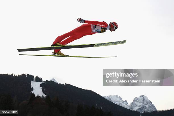 Michael Uhrmann of Germany soars over Germany's highest mountain Zugspitze and Waxenstein during the first round of the FIS Ski Jumping World Cup...