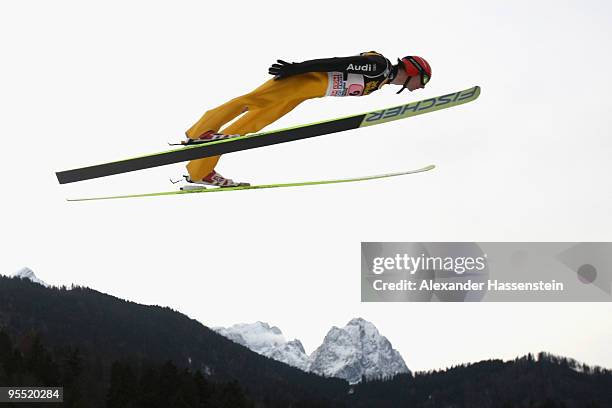 Andreas Wank of Germany soars over Germany's highest mountain Zugspitze and Waxenstein during the first round of the FIS Ski Jumping World Cup event...