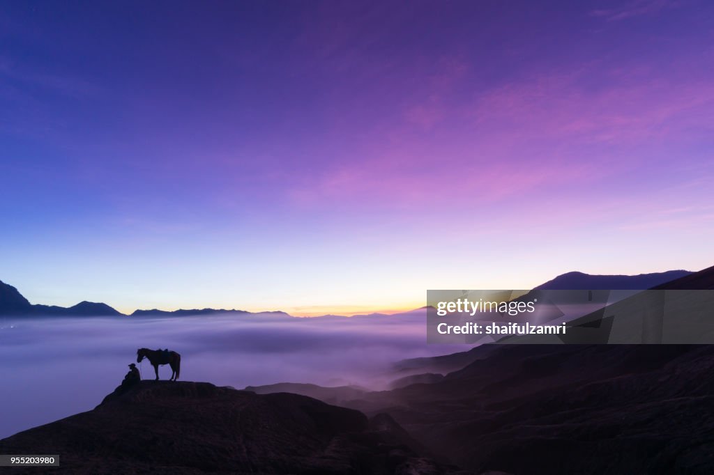 Silhouette of unidentified local people or Bromo Horseman at the mountainside of Mount Bromo, Semeru, Tengger National Park, East Java of Indonesia.