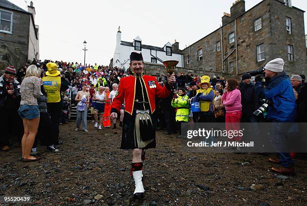 New Year revellers many in fancy dress, braved freezing conditions in the River Forth in front of the Forth Rail Bridge during the Loony Dook Swim on...