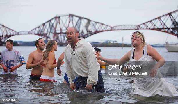 New Year revellers many in fancy dress, braved freezing conditions in the River Forth in front of the Forth Rail Bridge during the Loony Dook Swim on...