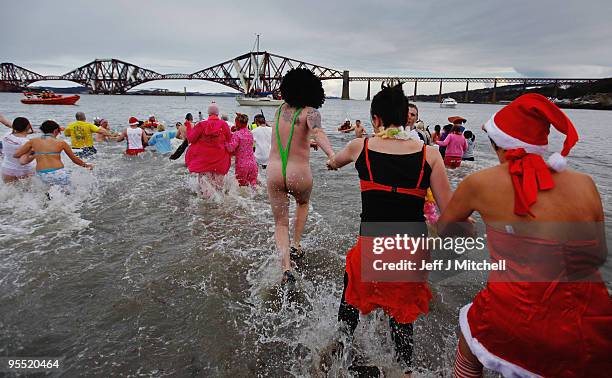 New Year revellers many in fancy dress, braved freezing conditions in the River Forth in front of the Forth Rail Bridge during the Loony Dook Swim on...