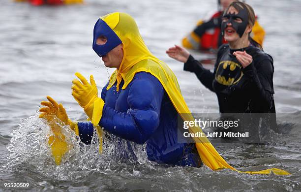 New Year revellers many in fancy dress, braved freezing conditions in the River Forth in front of the Forth Rail Bridge during the Loony Dook Swim on...