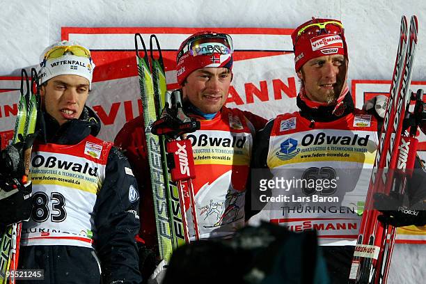 First placed Petter Northug of Norway , 2nd placed Marcus Hellner of Sweden and 3rd placed Axel Teichmann of Germany pose after the Men's 3,7km...
