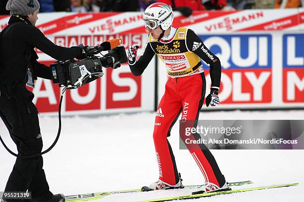 Simon Ammann celebrates after reaching the third place during the FIS Ski Jumping World Cup event of the 58th Four Hills Ski Jumping tournament at...