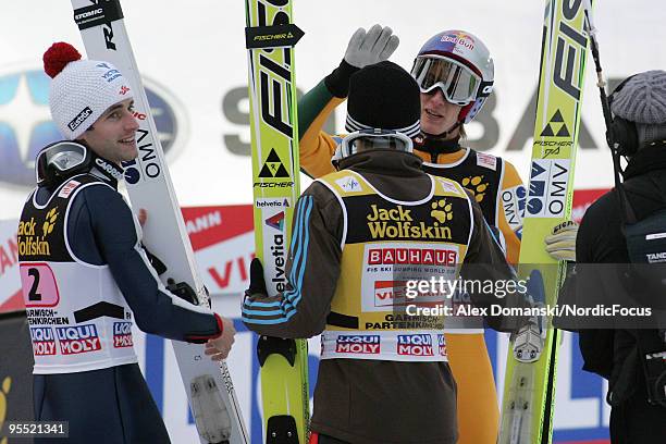 Wolfgang Loitzl of Austria , Simon Ammann of Switzerland and Gregor Schlierenzauer of Austria celebrate during the FIS Ski Jumping World Cup event of...