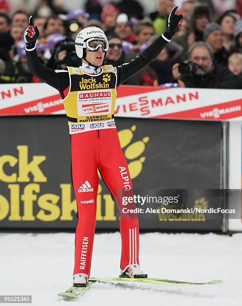 Simon Ammann celebrates after reaching the third place during the FIS Ski Jumping World Cup event of the 58th Four Hills Ski Jumping tournament at...