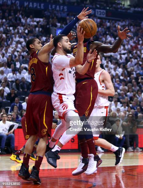 Fred VanVleet of the Toronto Raptors passes the ball as Jordan Clarkson and Jeff Green of the Cleveland Cavaliers defend in the first half of Game...