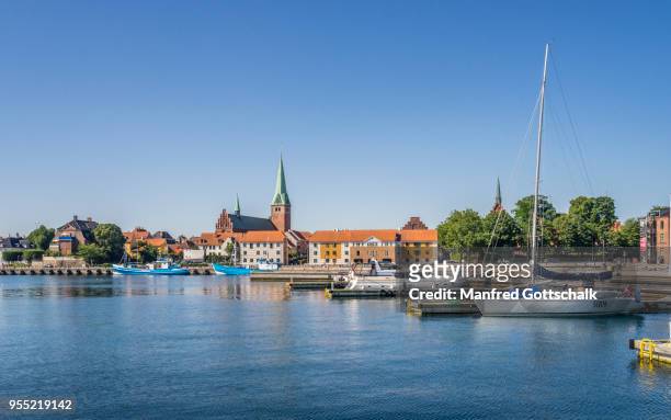 view of the helsingor harbourfront with the tower of saint olaf's church rising over the town roofs, helsingør, zealand, denmark - helsingør stock-fotos und bilder