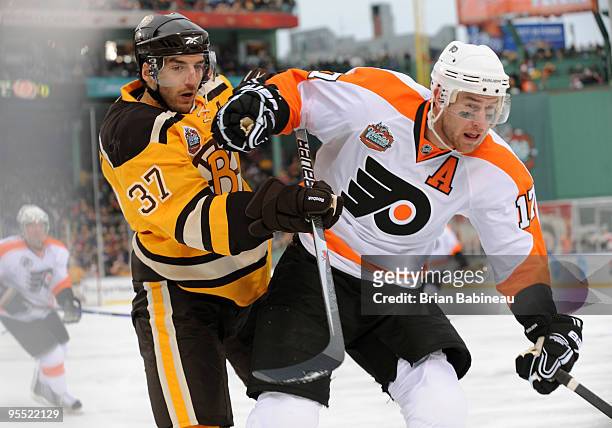 Patrice Bergeron of the Boston Bruins watches the play against Jeff Carter of the Philadelphia Flyers in the 2010 Bridgestone Winter Classic at...