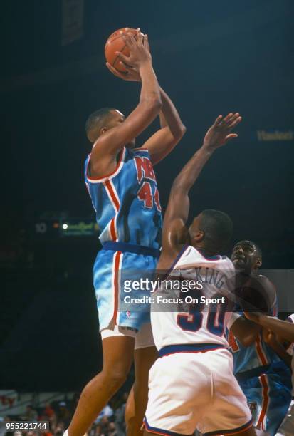Derrick Coleman of the New Jersey Nets shoots over Bernard King of the Washington Bullets during an NBA basketball game circa 1991 at The Capital...
