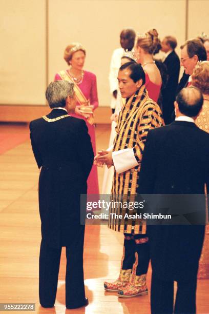 Emperor Akihito talks with King Jigme Singye Wangchuck of Bhutan as he introduces the 'Takamikura' thrones after the 'Kyoen-no-Gi' of the...