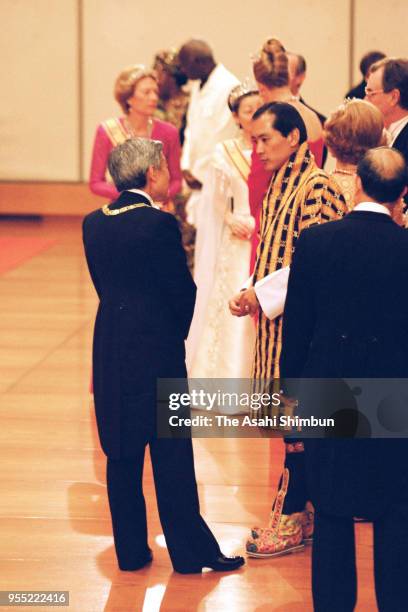 Emperor Akihito talks with King Jigme Singye Wangchuck of Bhutan as he introduces the 'Takamikura' thrones after the 'Kyoen-no-Gi' of the...