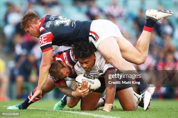 Moses Suli of the Sea Eagles is tackled by Dylan Napa of the Roosters and Jake Friend of the Roosters during the round nine NRL match between the...