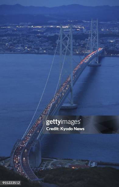 Photo taken from a Kyodo News helicopter on May 5 shows traffic congestion on the Kobe-bound lane of the Akashi Kaikyo Bridge in western Japan, as...