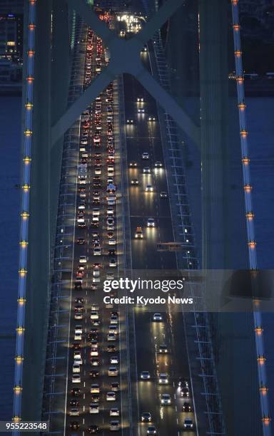 Photo taken from a Kyodo News helicopter on May 5 shows traffic congestion on the Kobe-bound lane of the Akashi Kaikyo Bridge in western Japan, as...