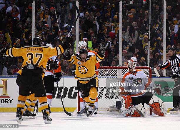 Mark Recchi of the Boston Bruins celebrates with teammates after he scored a third period goal to tie the game 1-1 against goalie goalie Michael...