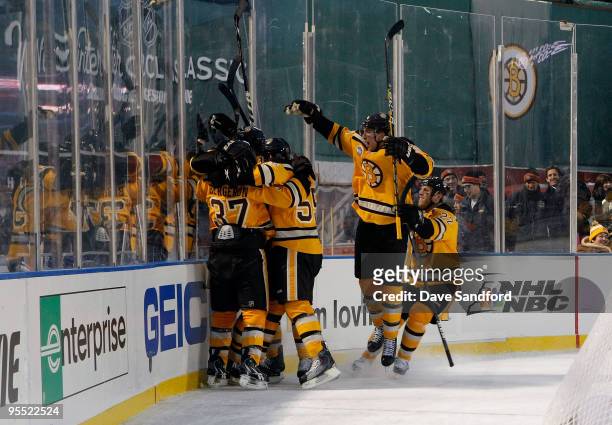 The Boston Bruins celebrate after Marco Sturm scored the game-winning goal in overtime to win 2-1 against the Philadelphia Flyers during the 2010...